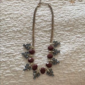Necklace with blue and dark crimson stones.